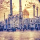 Traditional attire person admiring ornate mosque with minarets and blue tilework at sunrise/sunset