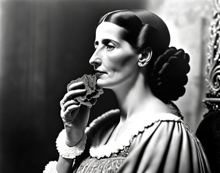 Vintage black and white portrait of woman with unique hairstyle and lacy fan