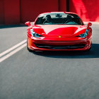 Sleek red sports car model with aggressive design on blurred backdrop