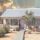 Charming beachfront cottage with white picket fence and pastel accents