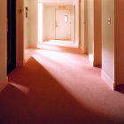 Luxurious Hotel Corridor with Purple Carpet, Cream Walls, and Ornate Chandelier