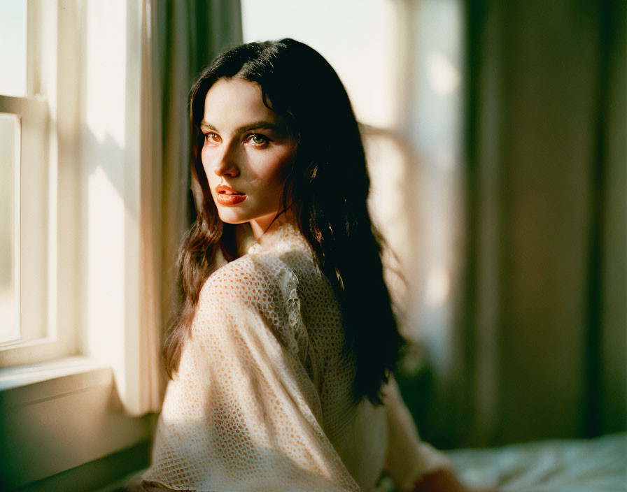 Dark-Haired Woman in White Textured Outfit Near Window