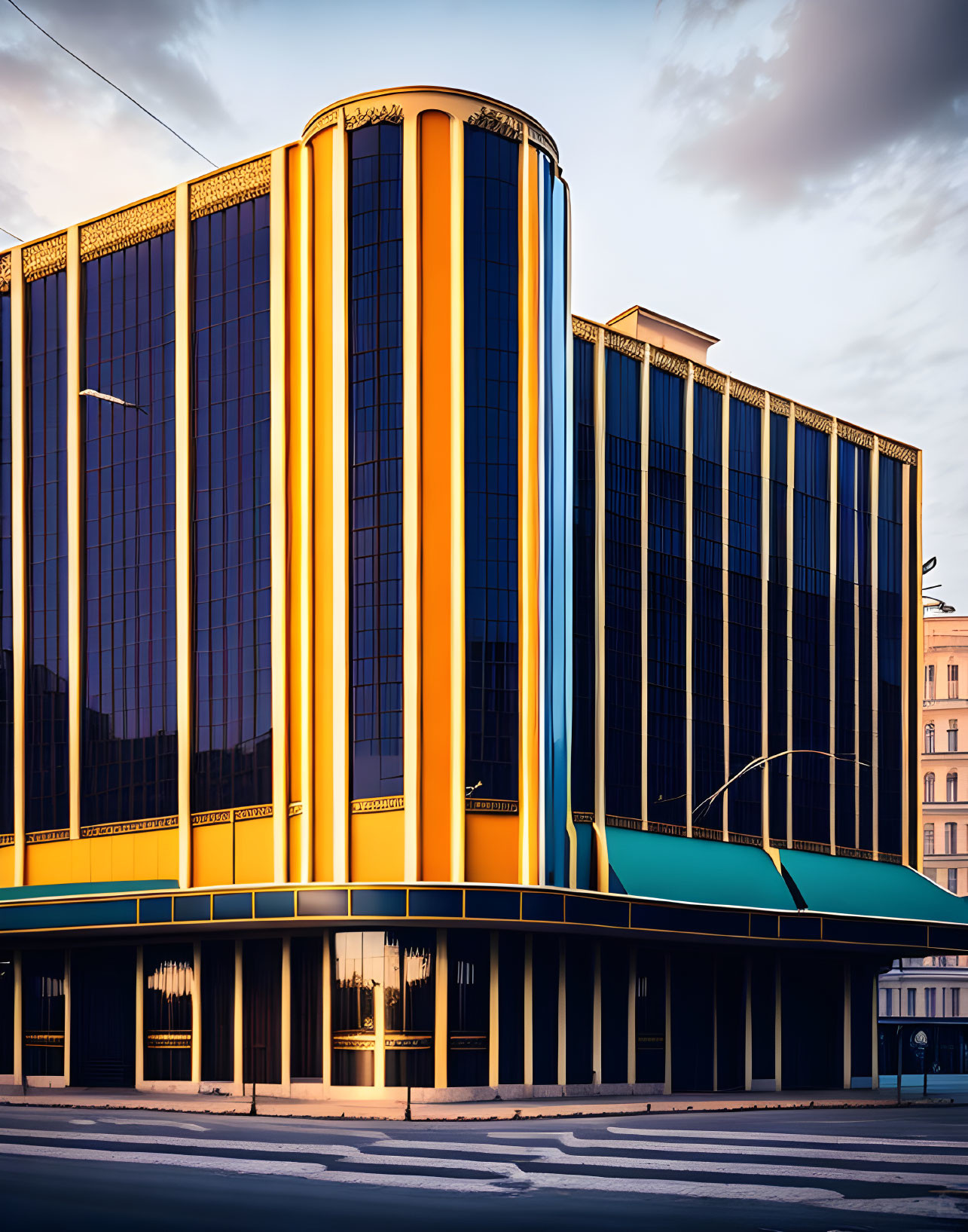 Modern building design with bold vertical lines in orange and teal hues under a dusk sky