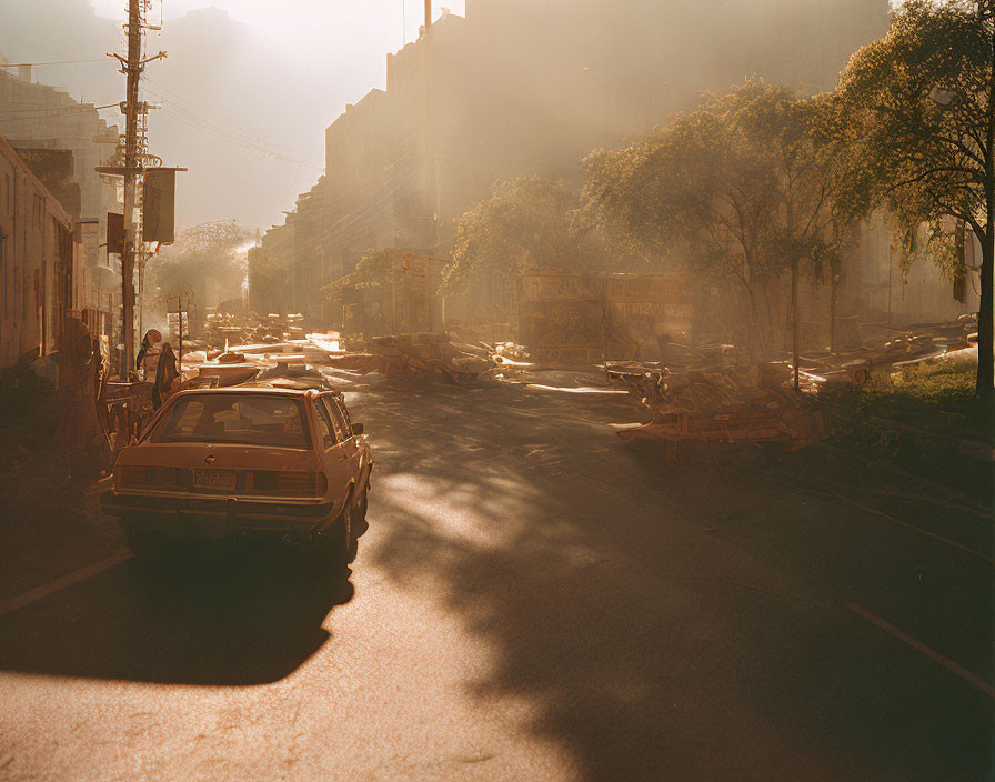 Vintage cars in sunlit urban street scene with long shadows and ethereal glow.