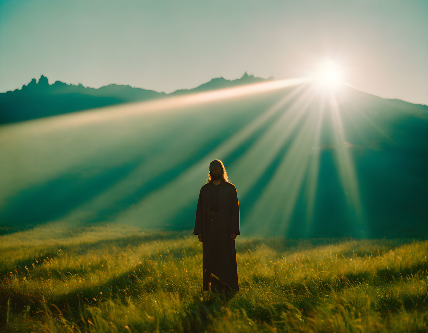 Person in Grass Field at Sunrise with Mountain Shadow