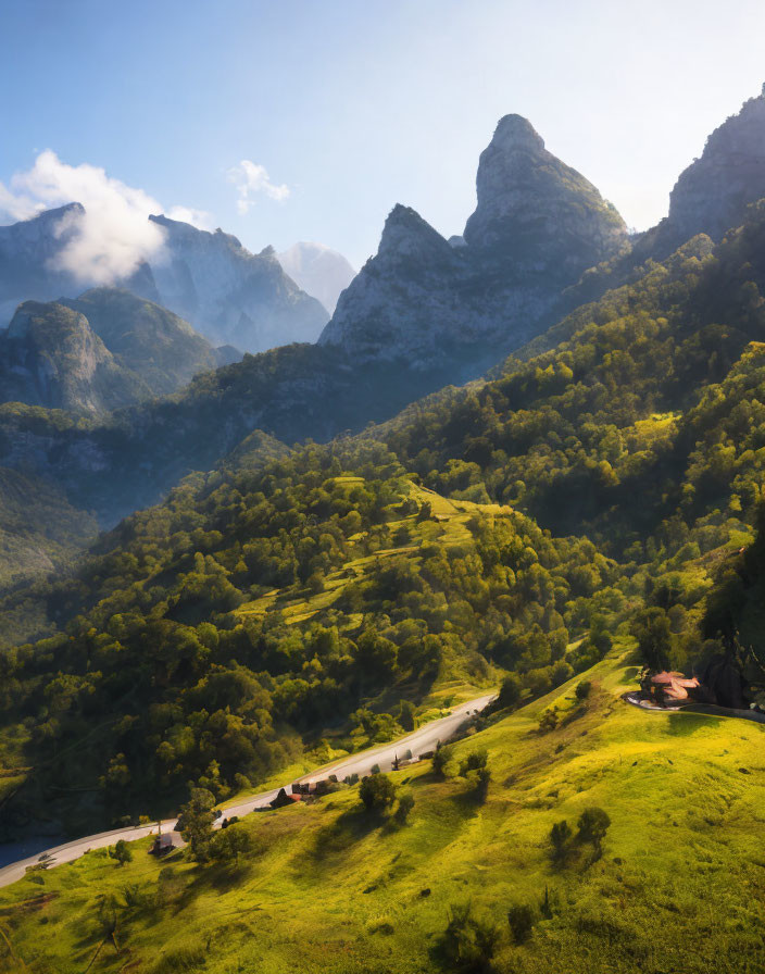 Scenic winding road through green hills and mountains in golden sunlight