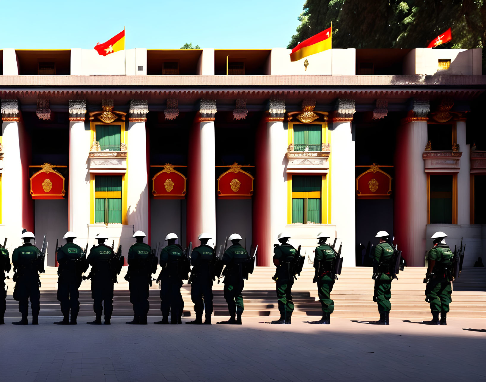 Uniformed security personnel in formation outside building with flags and classic architecture.