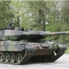 Modern Battle Tank on Paved Road with Camouflage Colors