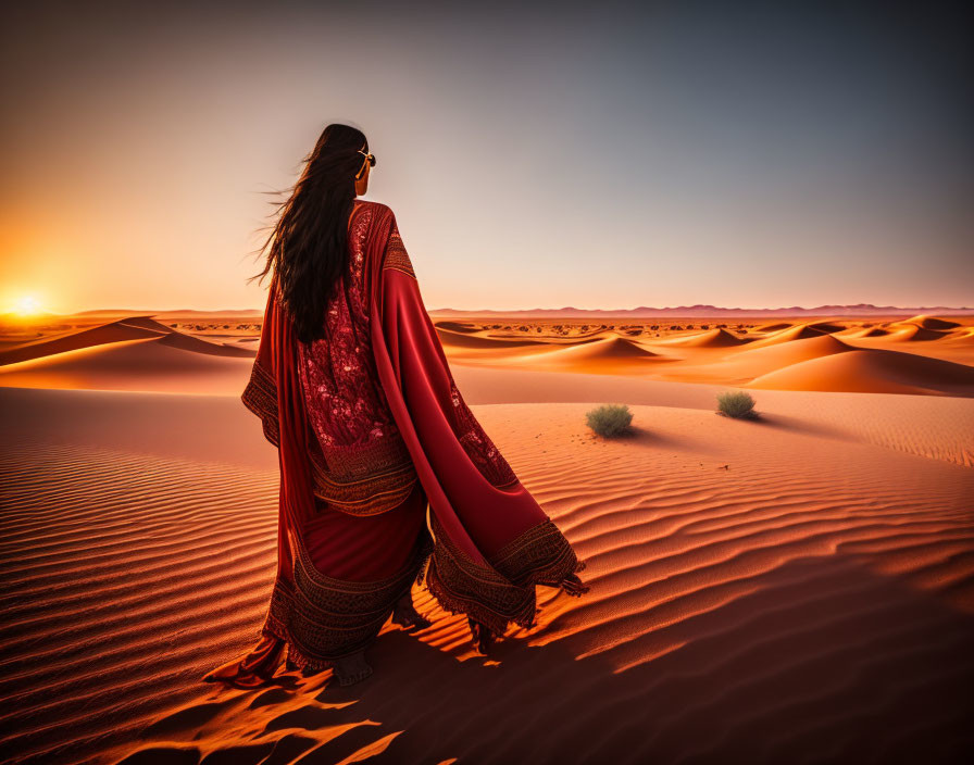 Woman in Red Dress Standing in Desert Dunes at Sunset