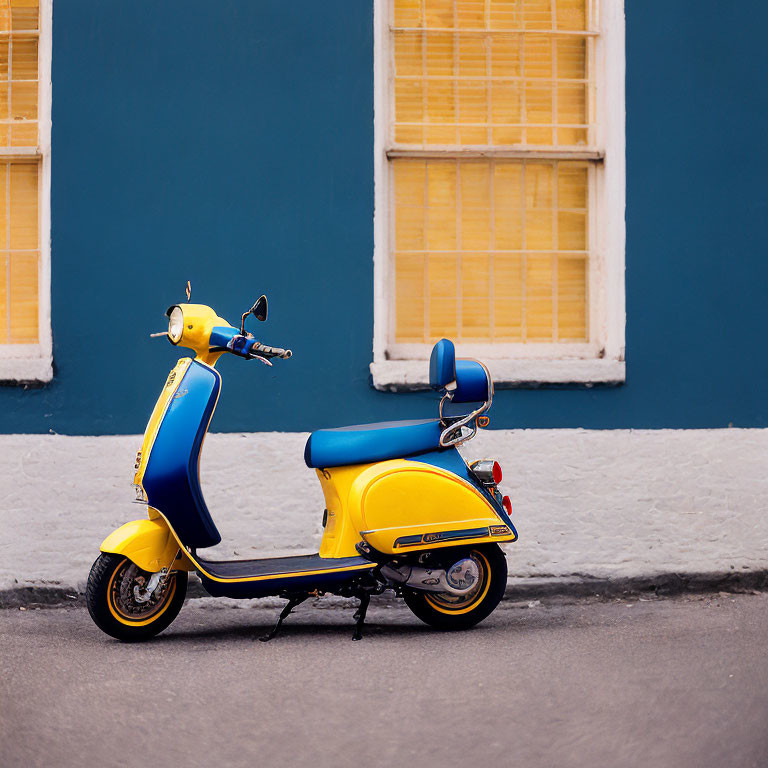 Yellow and Blue Scooter Next to Blue Building with Large White-Trimmed Window