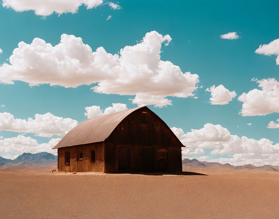 Isolated rustic wooden barn in sandy desert landscape