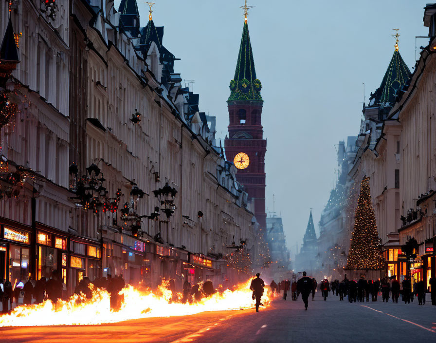 City street at twilight with Christmas decorations, large lit tree, and clock tower in the background.