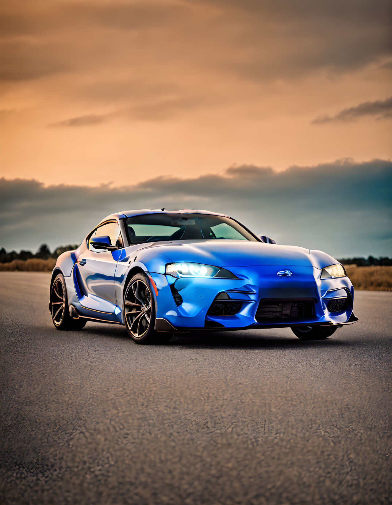 Sleek Blue Sports Car on Empty Road at Dusk