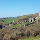 Panoramic painting of serene landscape with rolling hills and medieval-style buildings