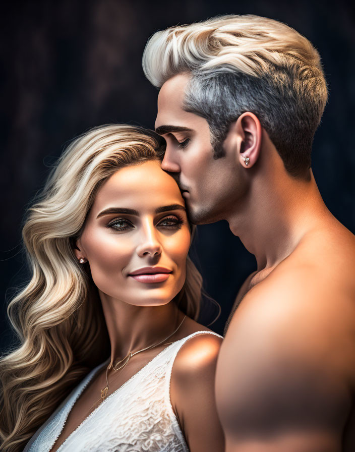 Blonde man kisses smiling woman on forehead against dark backdrop