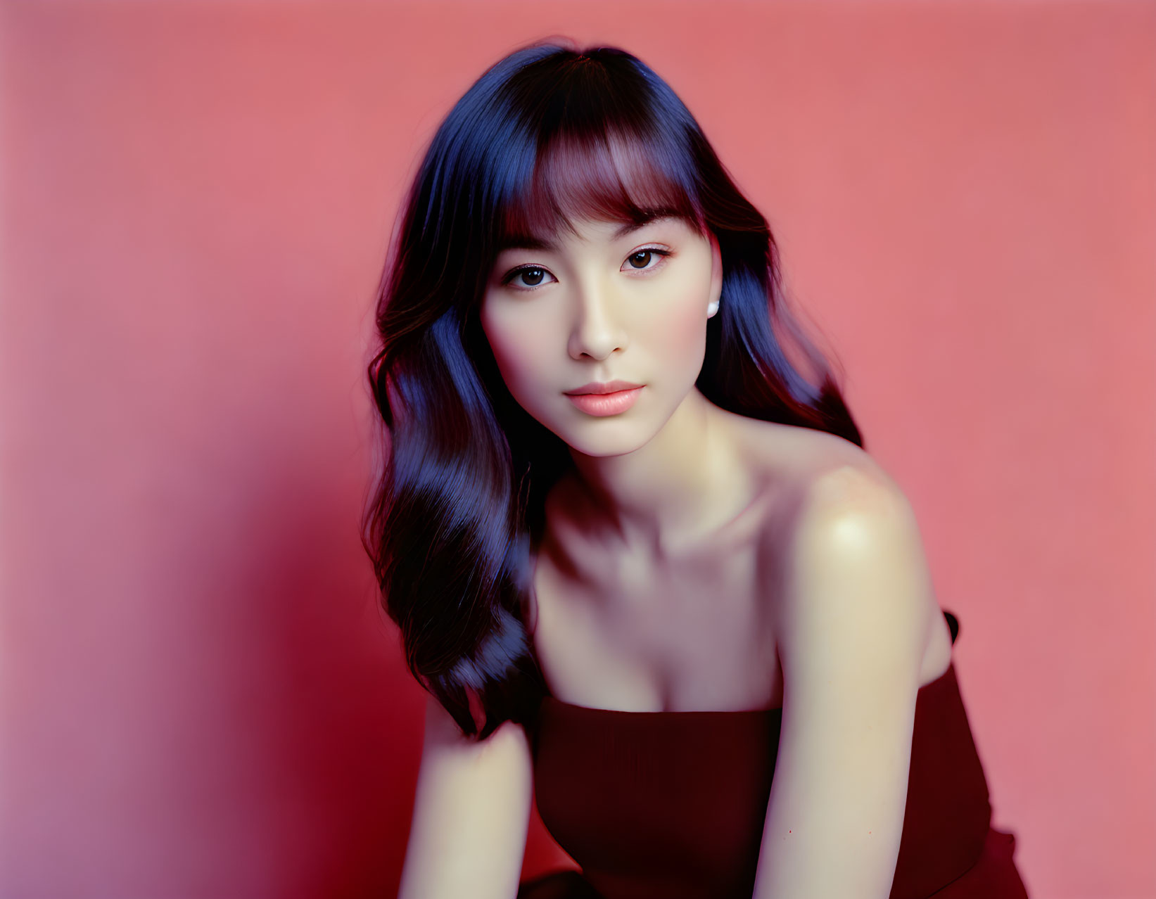 Woman with Blue Hair and Red Dress on Pink Background Portrait