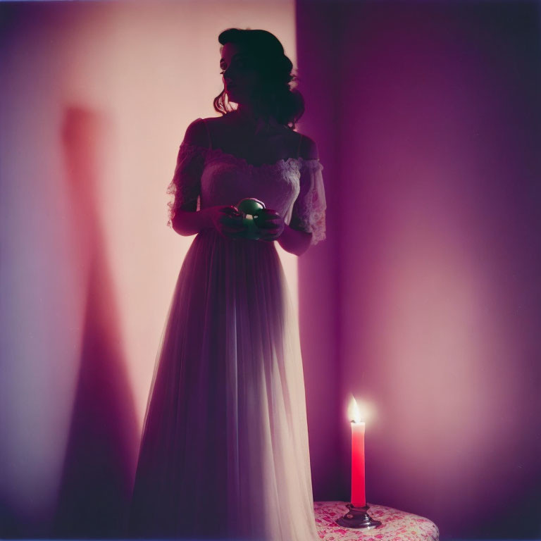 Vintage-dressed woman with candle and shadow holding object.