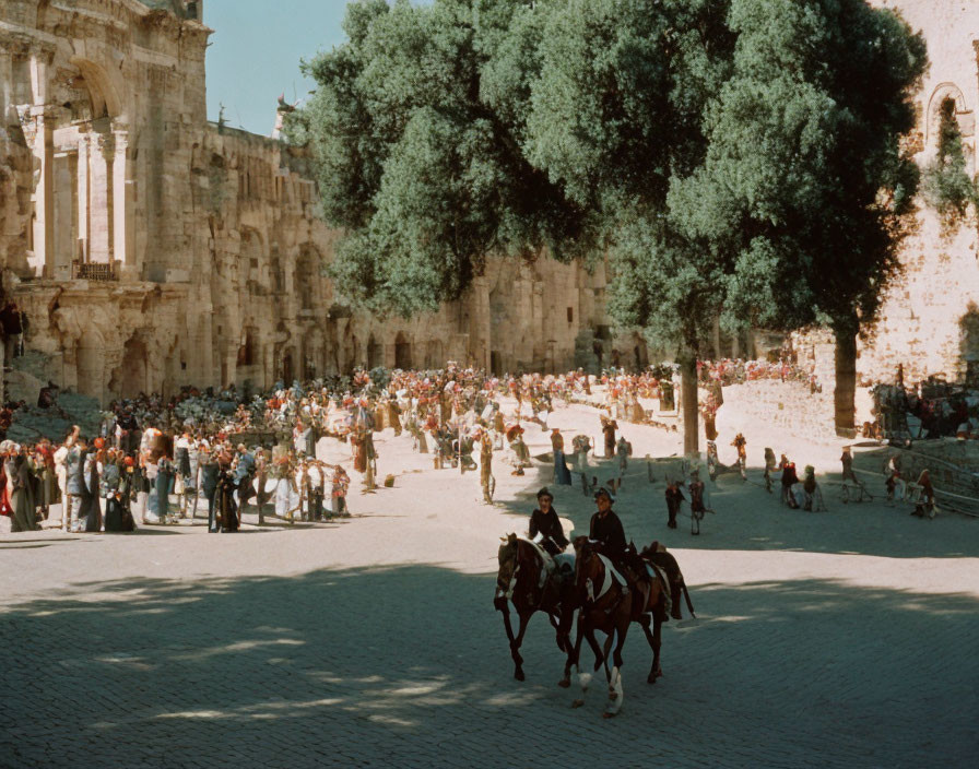 Horseback Riders near Ancient Ruins on Sunny Day