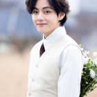 Man in White Suit Holding Bouquet of White Flowers