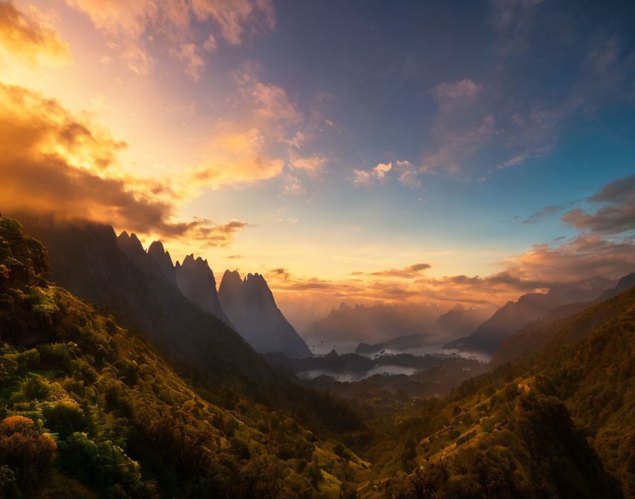 Majestic sunrise over sharp mountain peaks and misty valley