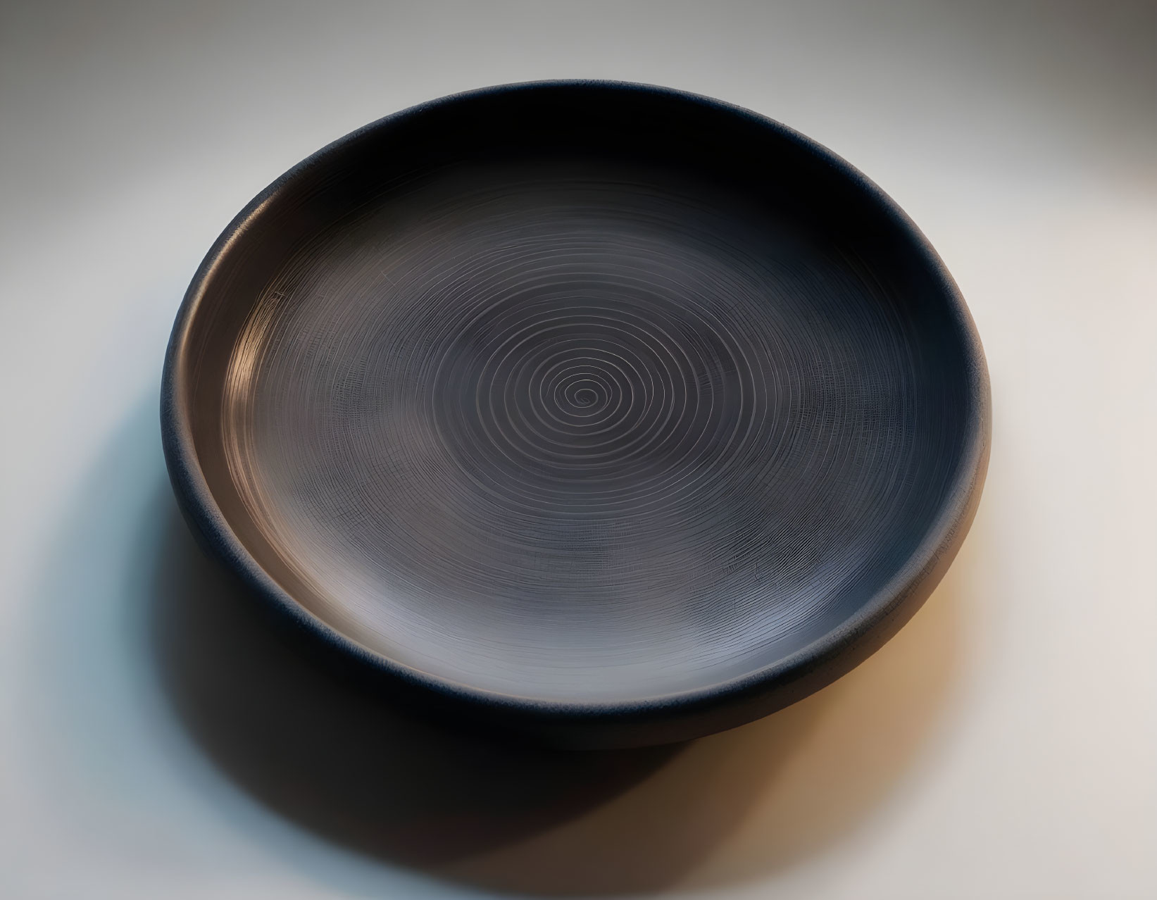 Smooth Circular Pattern Dark Ceramic Bowl on Gradient Background