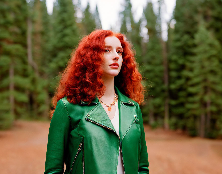 Curly Red-Haired Woman in Green Leather Jacket Standing in Forest