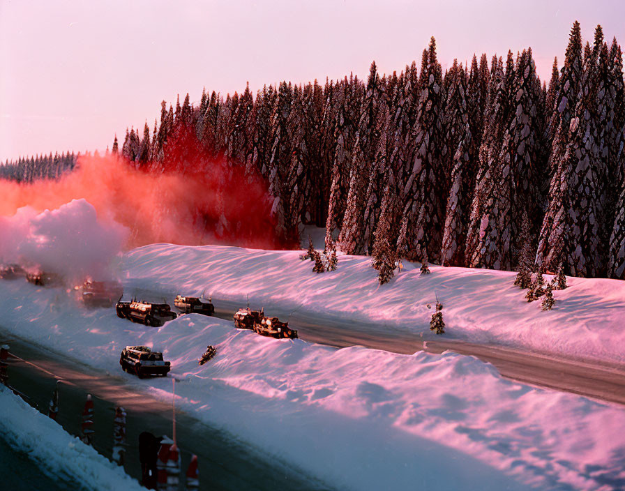 Military convoy on snowy forest road with red smoke flares at sunset or sunrise