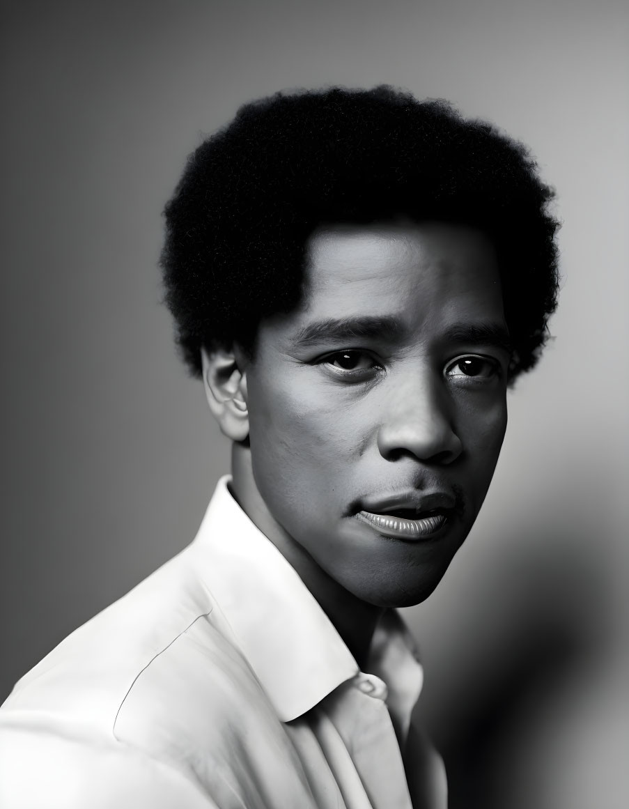 Monochrome portrait of man with afro hairstyle in white shirt