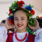 Portrait of a woman with floral headpiece, red shawl, and blue bead necklace