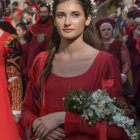 Artwork featuring woman in red dress with flowers, surrounded by somber figures in vibrant attire