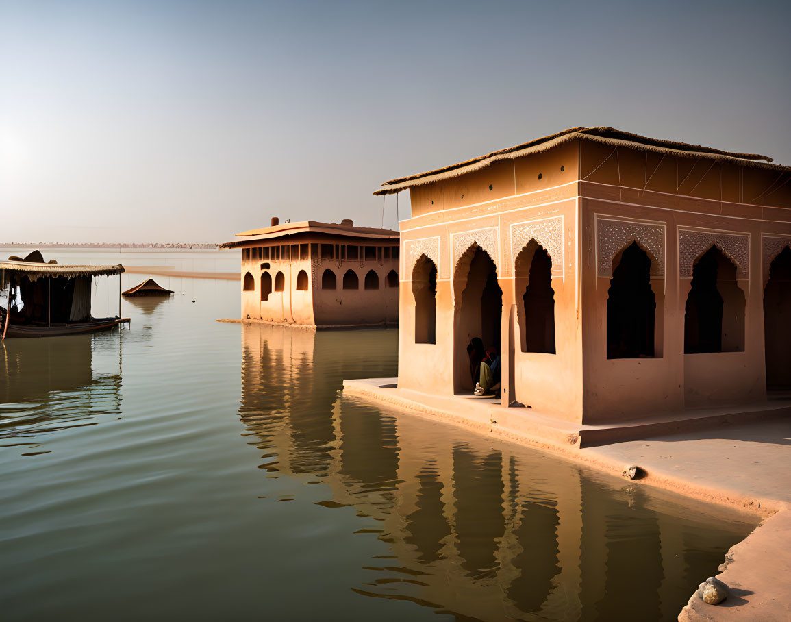 Tranquil sunset scene by water with traditional architecture