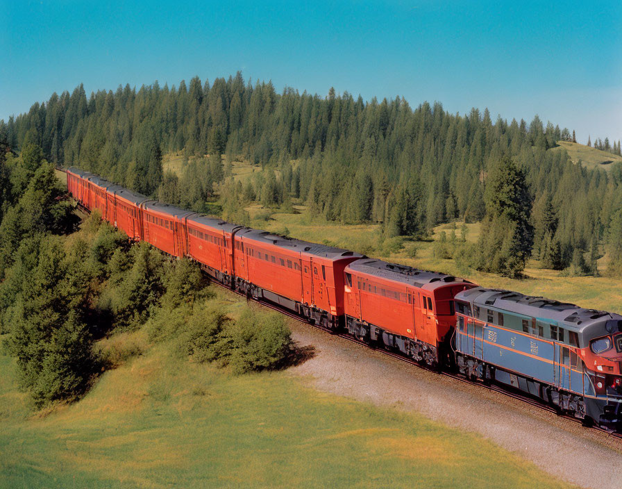 Red Passenger Train Passing Through Picturesque Landscape