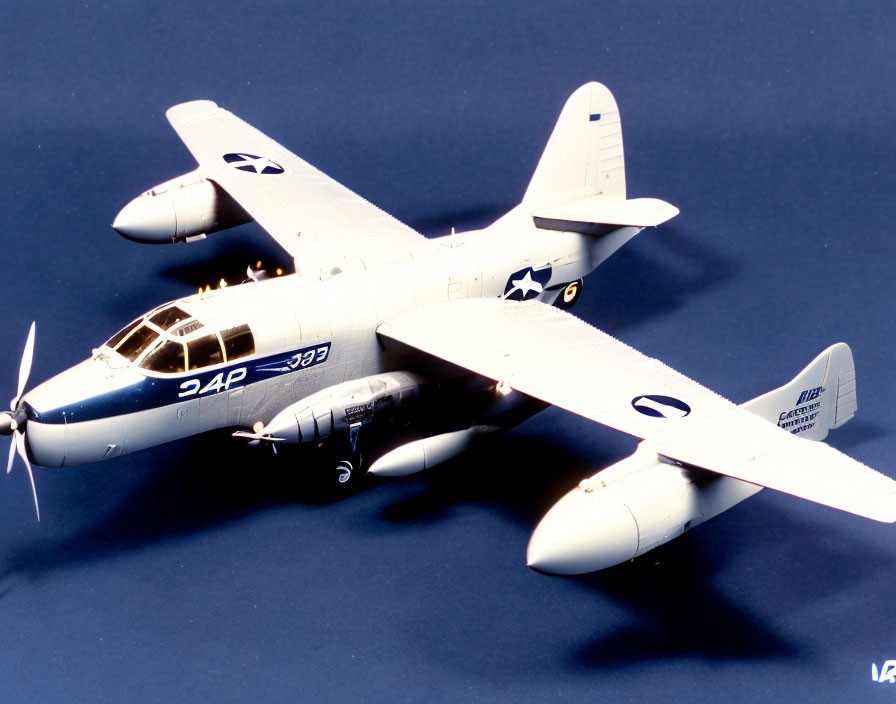 Twin-engine military aircraft with US Air Force markings and drop tanks on blue backdrop