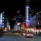 Vibrant city street at night with neon lights and skyscrapers