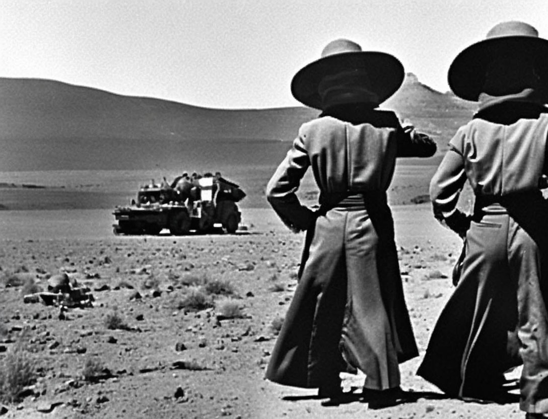 Two People in Wide-brimmed Hats and Long Coats Watching Car in Barren Landscape