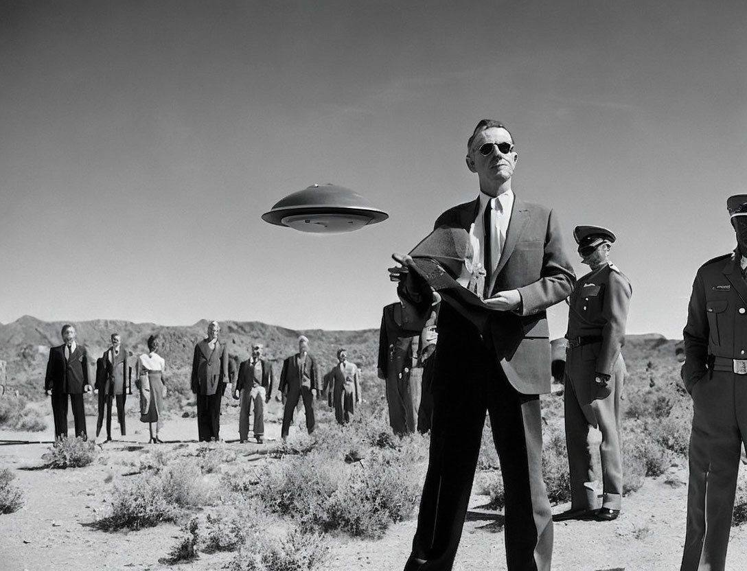 Monochrome image of man in suit with notepad, spectators, military personnel, and flying saucer