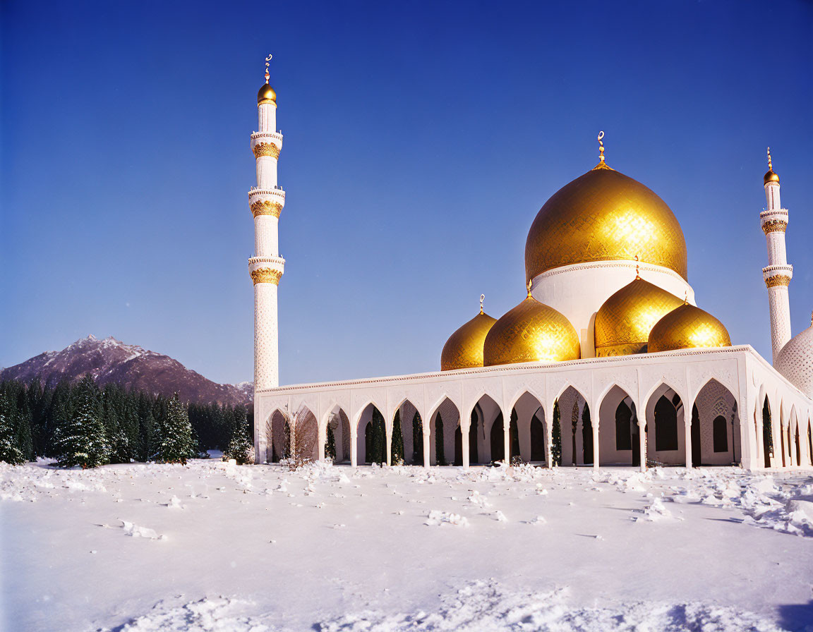 Golden domed mosque with minarets in snowy landscape