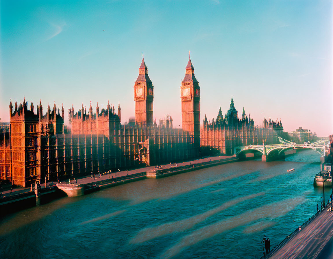 Iconic London skyline at sunset with Houses of Parliament and Big Ben by River Thames.