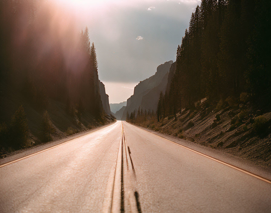 Scenic sunset view of empty road in mountainous landscape