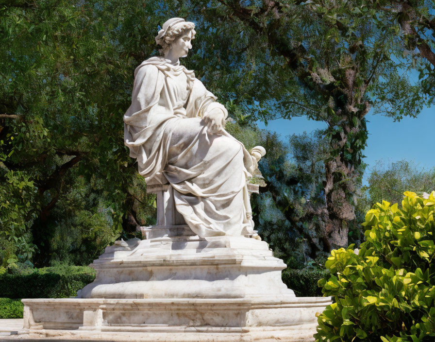 Seated robed figure statue in nature setting