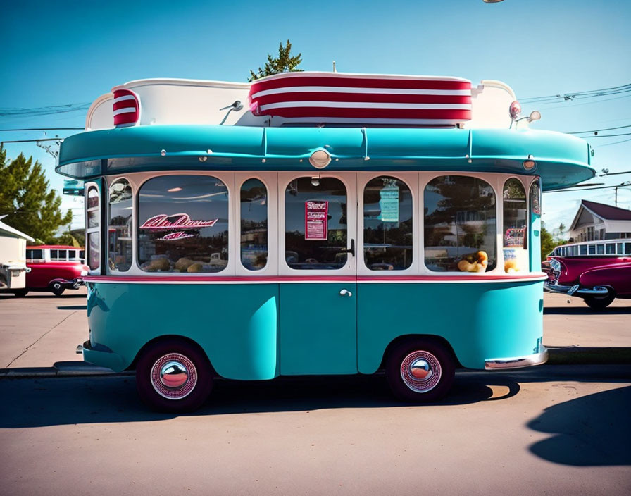 Vintage Turquoise and White Diner on Wheels with Retro Design under Clear Blue Sky