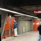 Subway station floor being painted with classical-style artwork on walls