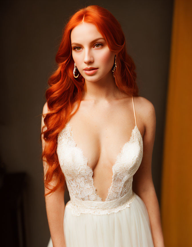 Red-haired woman in white lace dress on warm backdrop