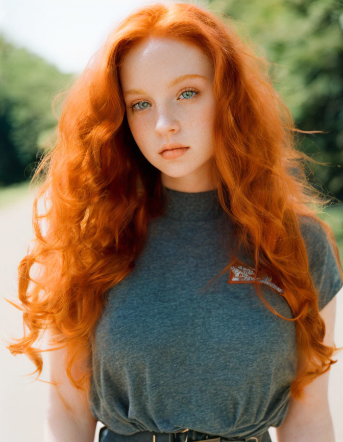 Person with Red Hair, Green Eyes, and Grey T-Shirt Outdoors