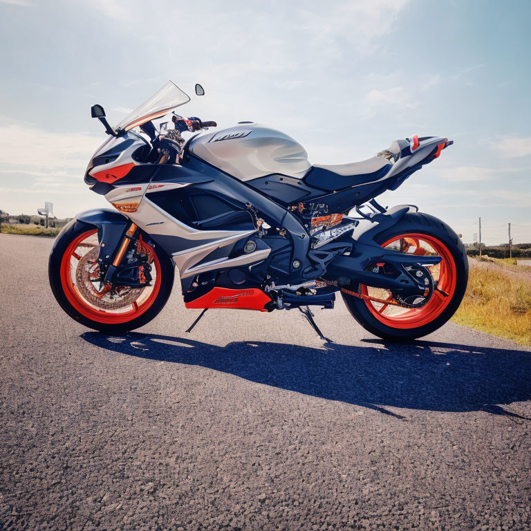 Blue and Silver Sport Motorcycle with Orange Wheels on Asphalt Road