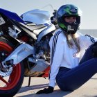 Woman in Racing Suit with Sport Motorcycle on Highway