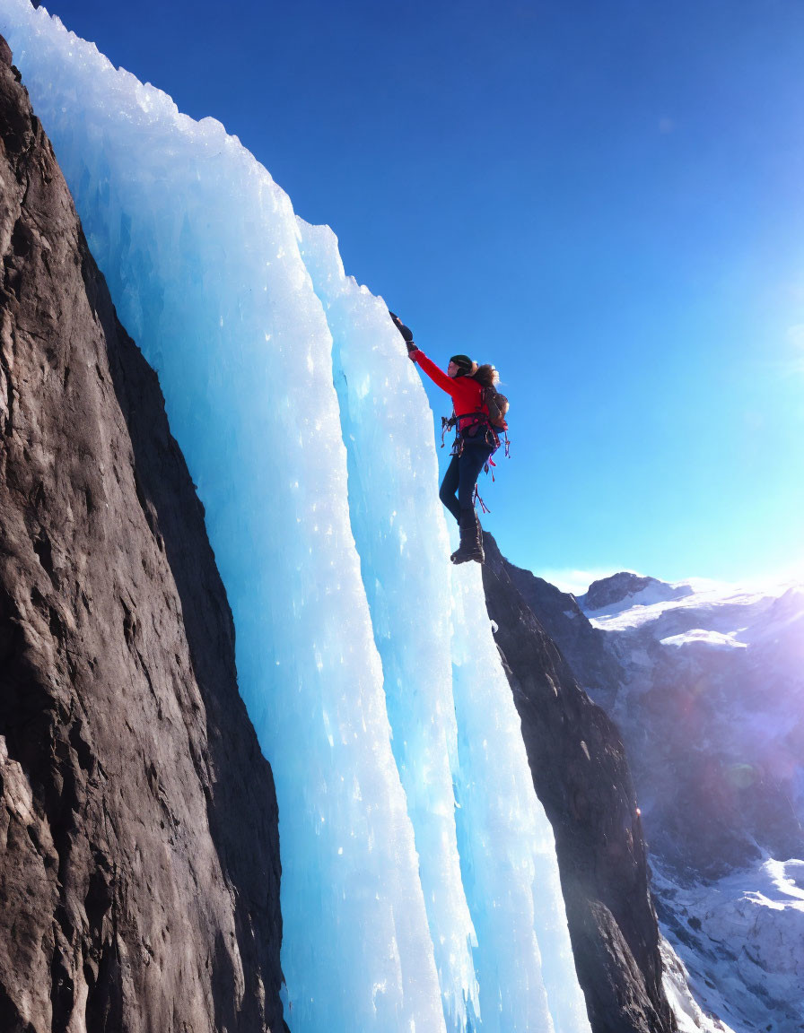 Climber ascending glowing blue ice formation with ice axes