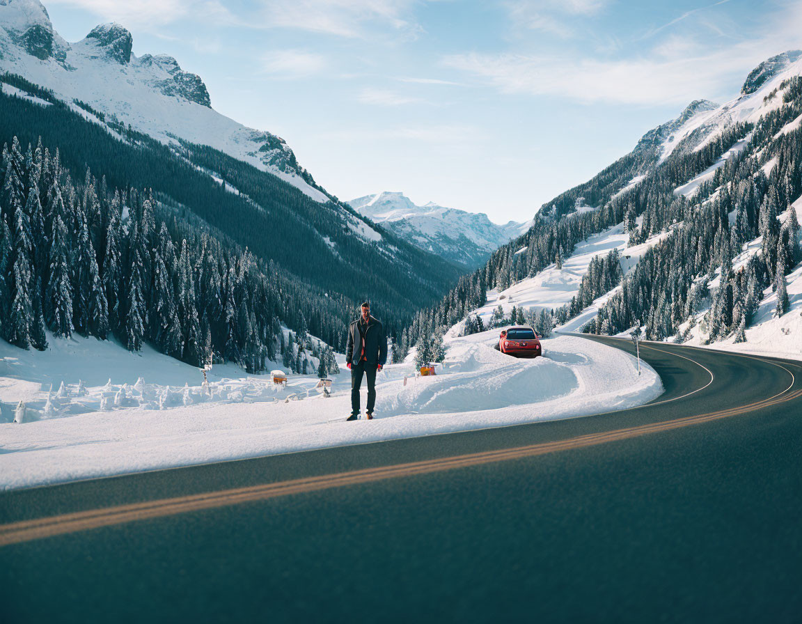 Person standing on snowy mountain road with pine trees and red car in background