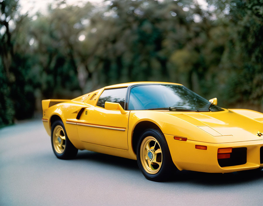 Yellow Sports Car with Pop-Up Headlights Parked on Road Amid Greenery