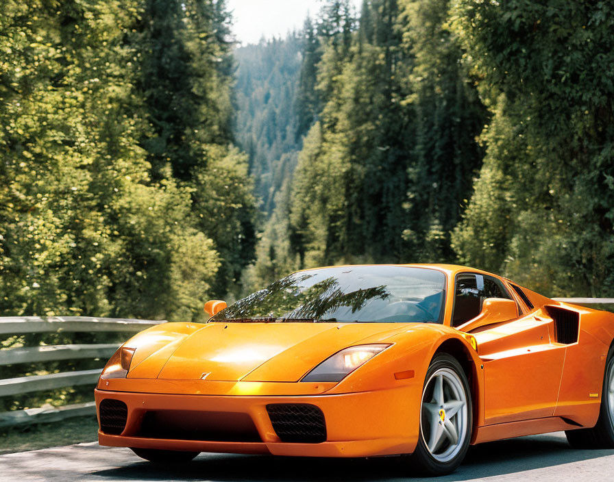 Vibrant orange sports car on forest road under blue sky